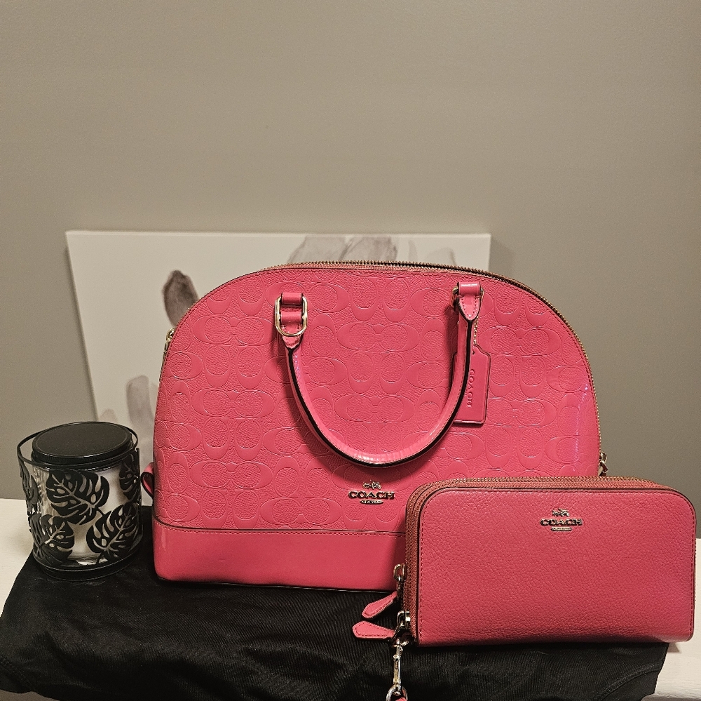 Pink Coach clutch with strap along with coach wallet